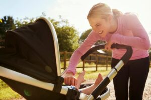 Postnatal exercise - an expert guide to running after giving birth woman with child in buggy